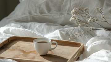 Soft pillows with a delicate flower, symbolizing calm and rest. Visual for the Talk2Tessa sleep blog about releasing the struggle with sleepless nights using ACT, self-compassion, and AI Prompt Flows