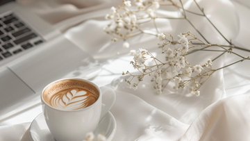 Laptop with flowers on a calm desk — representing Talk2Tessa’s pillar guide on using AI safely for self-help with ACT, self-compassion, and psychologist-designed Prompt Flows.