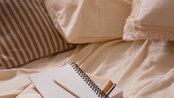 A journal on a bed in soft light, symbolizing a calming affirmations night routine for sleep, overthinking, and gentle emotional support — Talk2Tessa psychologist-written guide.