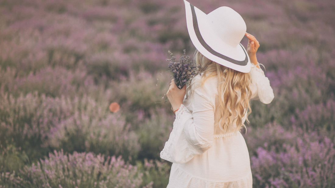 Woman standing in a flower field symbolizing becoming herself, self-trust and gentle emotional growth — Talk2Tessa psychologist-written guide.