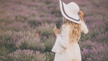 Woman standing in a flower field symbolizing becoming herself, self-trust and gentle emotional growth — Talk2Tessa psychologist-written guide.