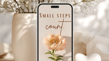iPhone mockup with a calm beige affirmations wallpaper reading ‘Small steps count’, placed among soft flowers, representing gentle growth, self-compassion and the psychologist-designed Talk2Tessa guide to iPhone affirmation wallpapers.