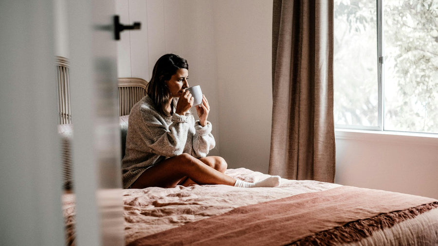Calm morning scene with a warm drink and a quiet resting moment in soft sunlight, representing burnout recovery and gentle slowing down.