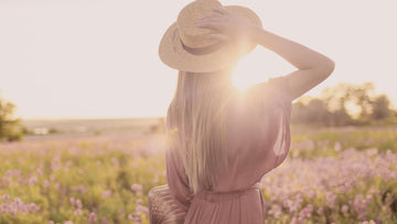 Woman standing in warm spring sunlight, symbolising gentle growth, calm and emotional renewal — hero image for psychologist-written spring affirmations