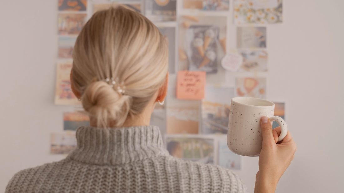 Woman creating a calm vision board at home, symbolizing gentle goal-setting and psychologist-written vision board affirmations.