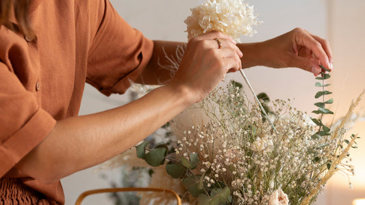 Woman arranging flowers at home as a calming, gentle self-care ritual for stress relief, perfectionist burnout recovery, nervous system soothing, and emotional reset — Talk2Tessa.